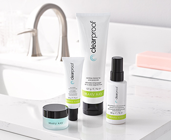 Clear Proof® Acne System in while, green and black tubes on a bathroom counter with the teal, transparent Indulge® Soothing Eye Gel