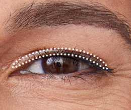 Extreme close up of a hooded eye with dotted outline for base eye shadow placement.