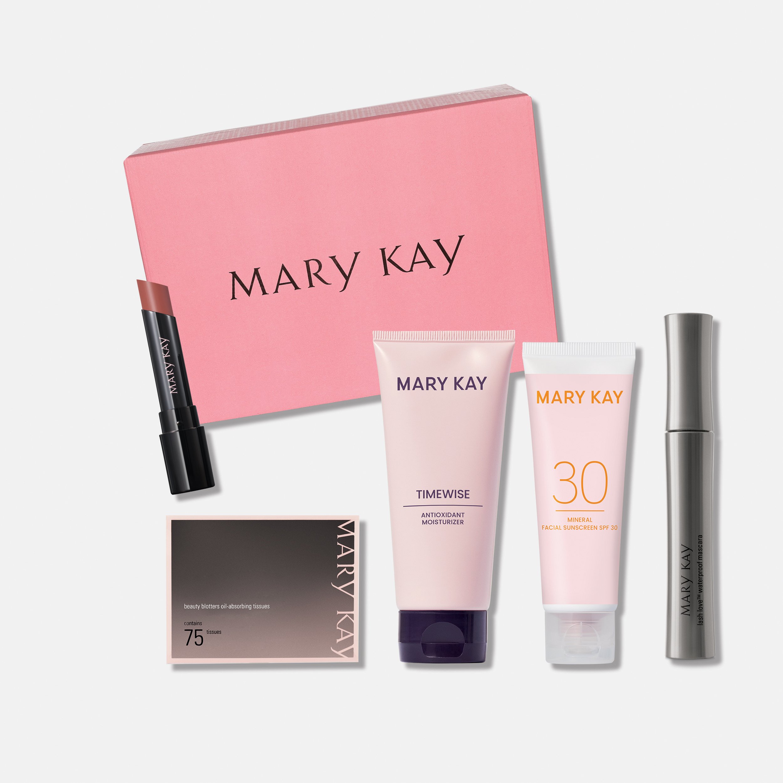 Rosa Summer Beauty Box mit Produkten und gratis Lippenstift, arrangiert auf weißem Hintergrund.