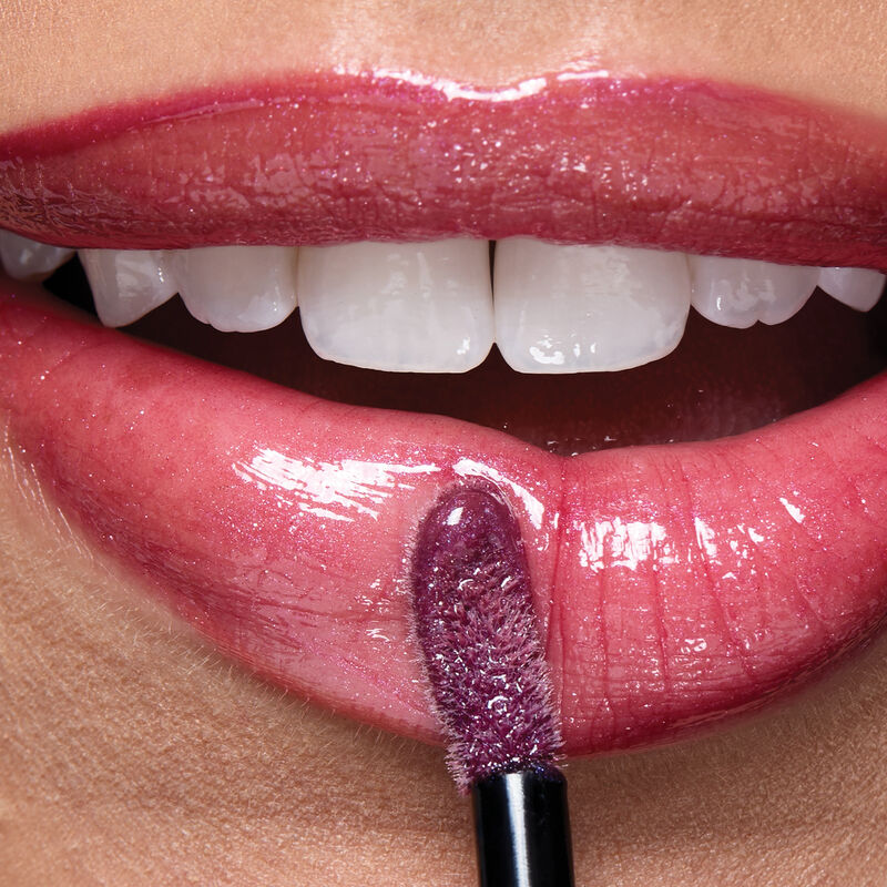 Macro of lips wearing Lilac Love with applicator.&nbsp;