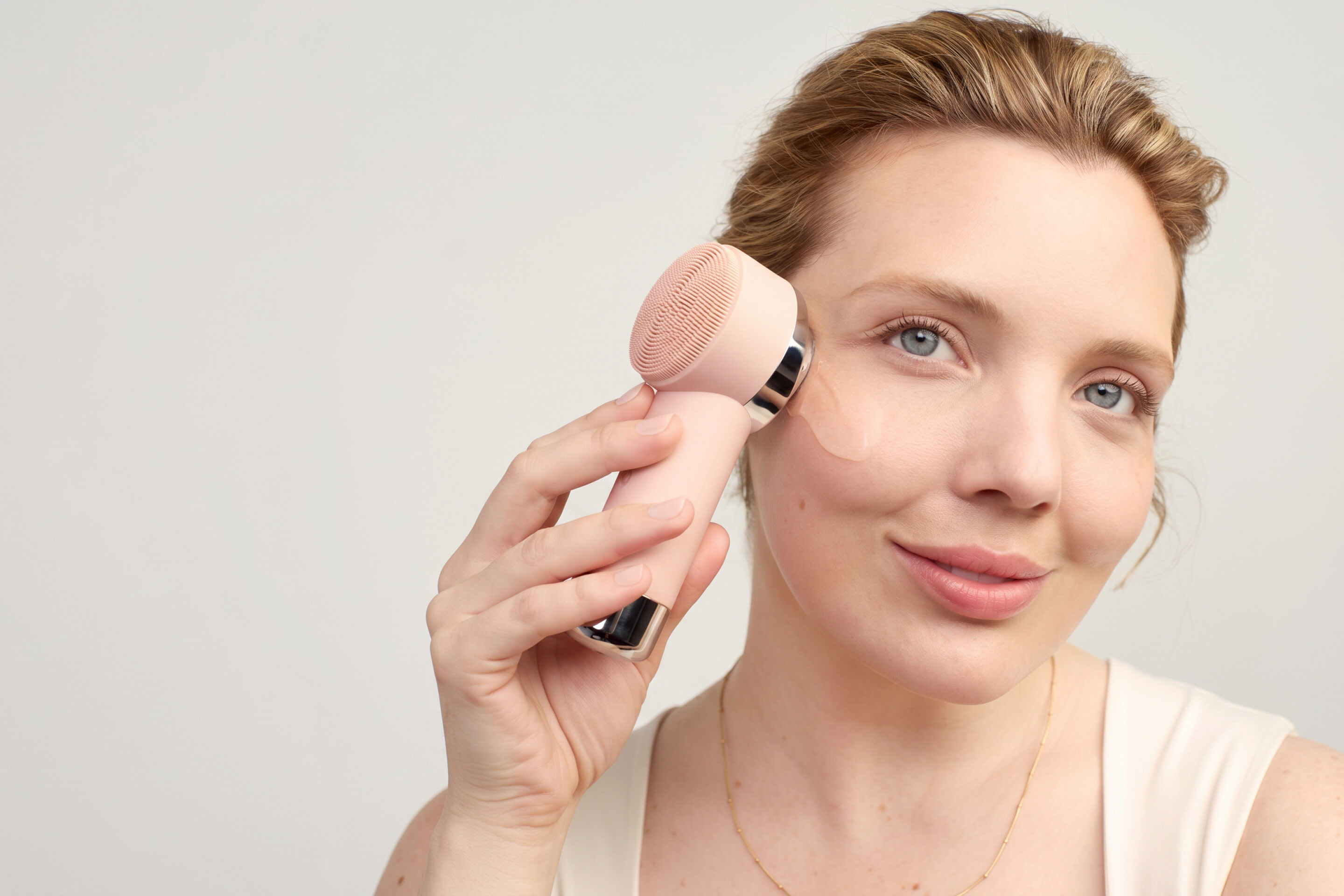 Eine Frau wendet das Mary Kay Skinvigorate Duo Facial Device im Gesicht an: Mit der w&auml;rmenden Massagefunktion unterst&uuml;tzt sie die Aufnahme des Gesichtsserums