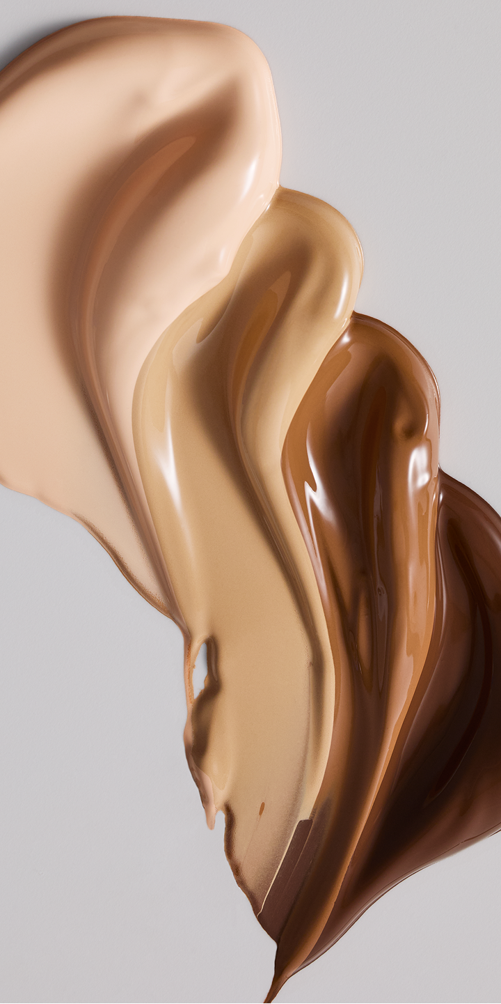 Mehrere Farbt&ouml;ne der TimeWise&reg; Luminous 3D Foundation mit strahlendem Finish.