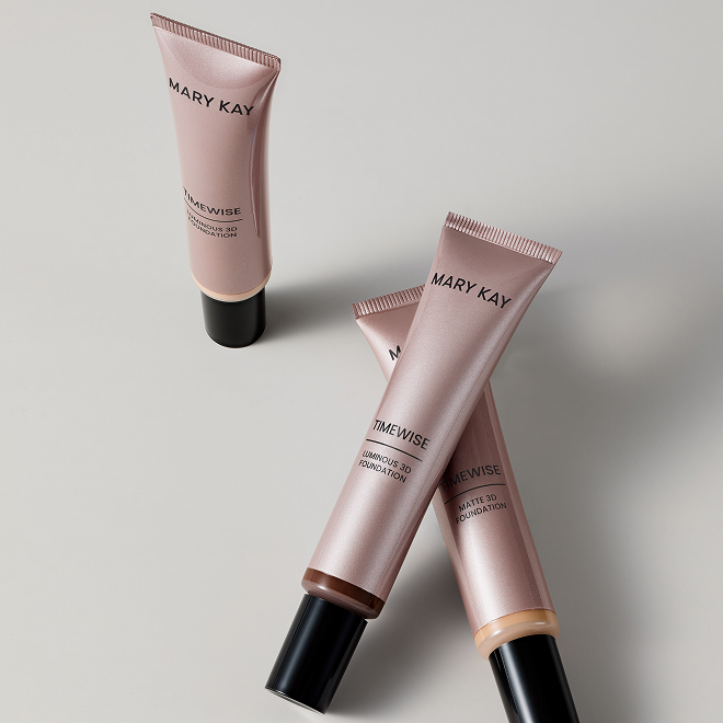 Three tubes of Mary Kay TimeWise 3D Foundation arranged on a light surface